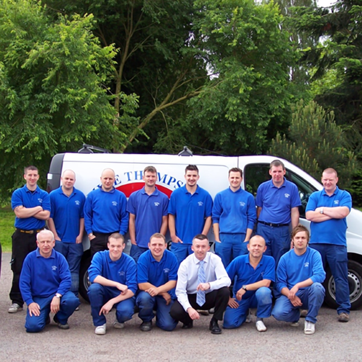 The Mike Thompson Electrical team in company uniforms in front of a liveried van