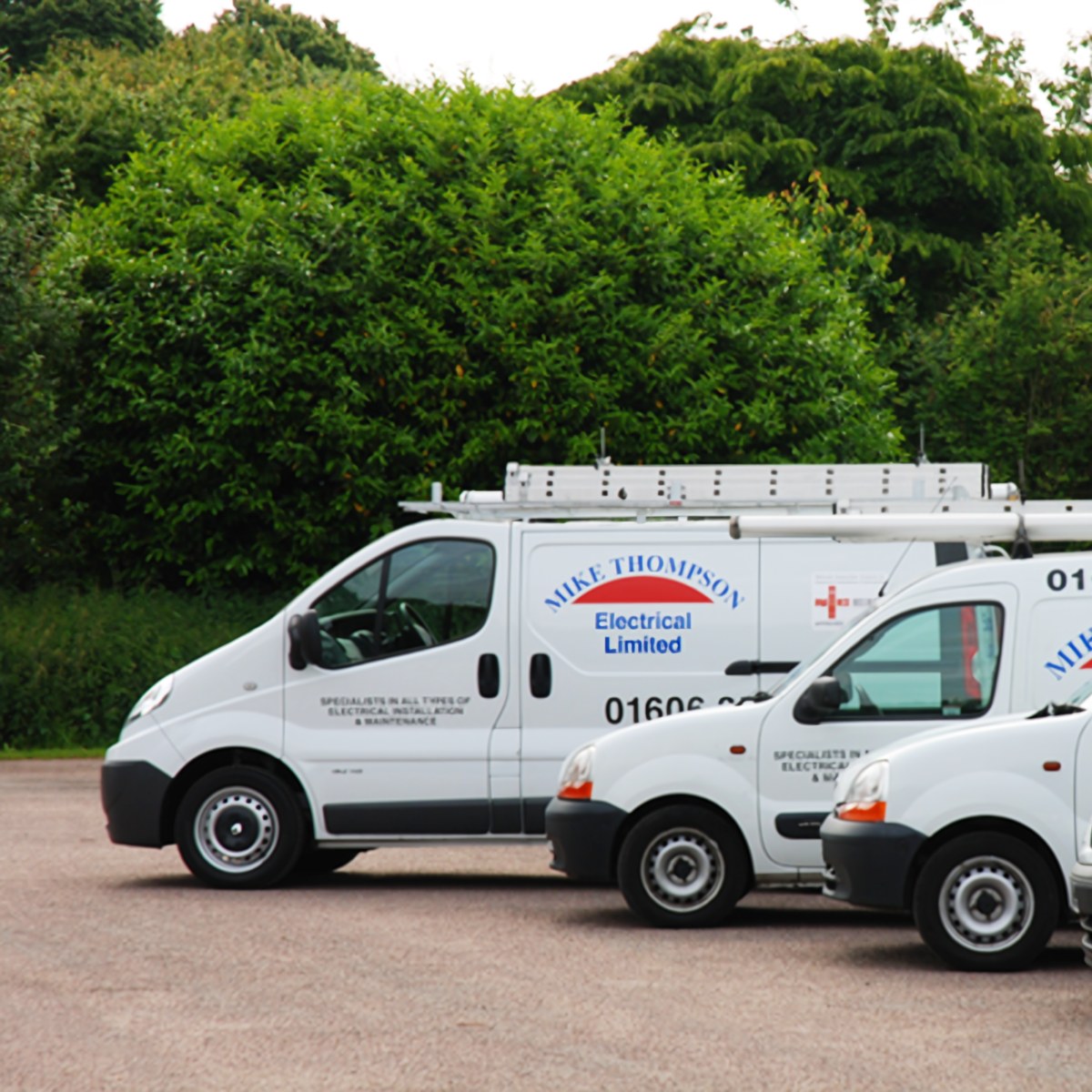 Mike Thompson Electrical liveried vans parked on site